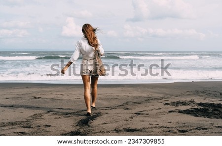 Similar – Image, Stock Photo Anonymous traveling woman on rocky seashore