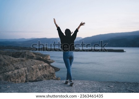 Similar – Image, Stock Photo Unrecognizable female traveler enjoying sunny day on rocky seashore