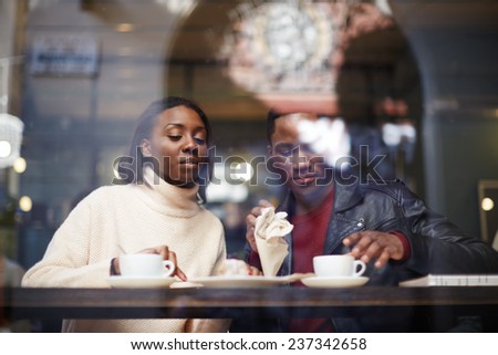 Two young friends talk and drink coffee in cafe, good friend enjoying coffee in beautiful place, cold winter days in beautiful coffee shop, friend at breakfast having coffee and enjoying themselves