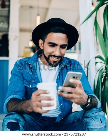 Similar – Image, Stock Photo Brutal man browsing smartphone in backyard