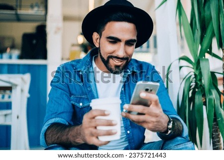 Similar – Image, Stock Photo Brutal man browsing smartphone in backyard