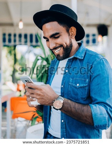 Similar – Image, Stock Photo Brutal man browsing smartphone in backyard