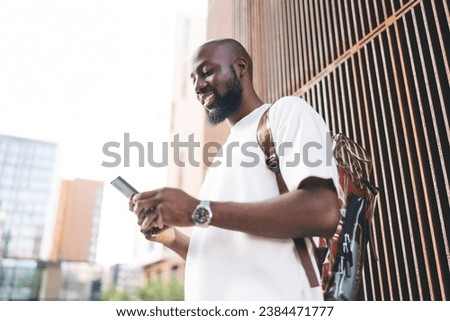 Similar – Image, Stock Photo Cheerful black man using smartphone in cafe