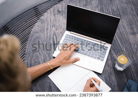 Similar – Image, Stock Photo Anonymous woman taking notes in notebook while working on laptop