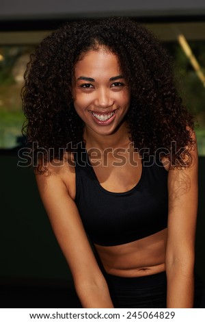 Portrait of afro american woman looking happy with brilliant smile, attractive girl in sport clothes smiling looking to the camera