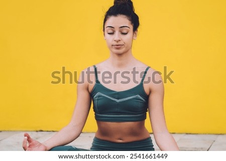 Similar – Image, Stock Photo Slim barefoot woman meditating in bound angle pose in contemporary workout room