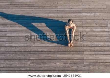 Similar – Image, Stock Photo Anonymous woman stretching body in seated forward bend position