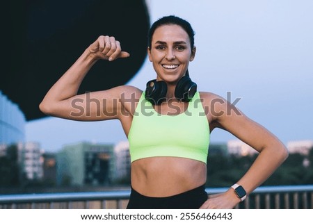 Similar – Foto Bild Fröhliche ethnische Sportlerin beim Headset-Training am Stadtfluss