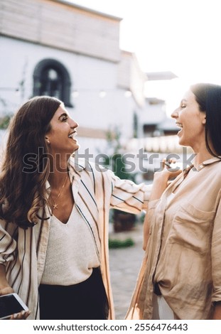 Similar – Image, Stock Photo Delighted female friends walking along street