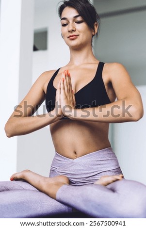 Similar – Image, Stock Photo Slender barefooted woman stretching body in bound angle pose in contemporary studio