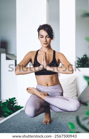 Similar – Image, Stock Photo Slender barefooted woman stretching body in bound angle pose in contemporary studio