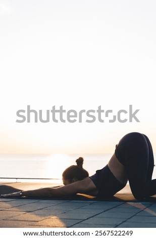 Image, Stock Photo Anonymous sportswoman practicing yoga on street