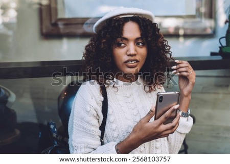 Similar – Foto Bild Friedliche Frau, die auf der Promenade bei Sonnenuntergang auf ihrem Smartphone surft