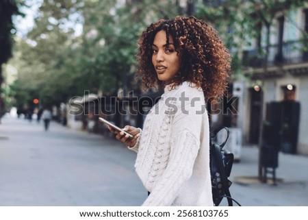 Similar – Image, Stock Photo Stylish businesswoman walking along street in city