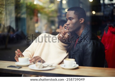 Portrait of young beautiful couple in love having coffee in beautiful cafe, two people in cafe enjoying the time spending with each other