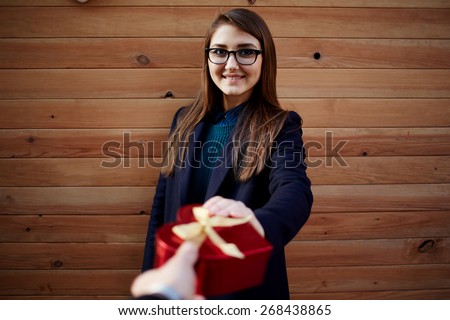 Portrait of attractive young woman receives or takes a shape heart gift from her boyfriend