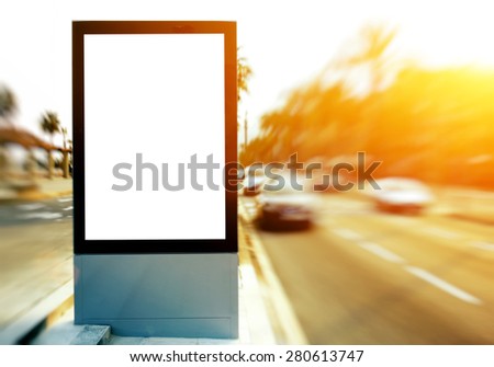 Blank billboard with copy space for your text message or content, outdoors advertising mock up, public information board on city road, flare sun light and motion blur effect with ride cars and taxi