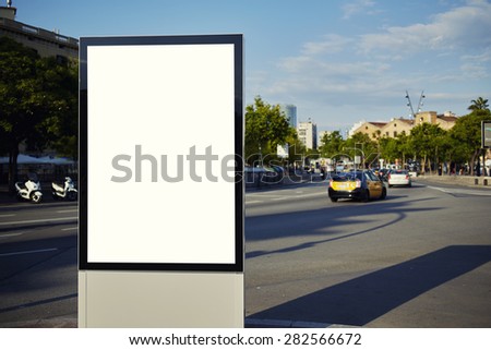 Blank billboard with copy space for your text message or content, public information board in the big city, advertising mock up empty banner in metropolitan city at beautiful sunny day