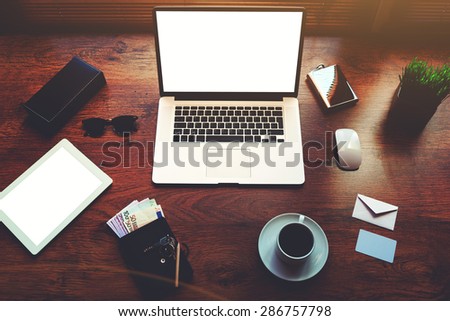 Top view of modern businessman or entrepreneur table with style accessories,euro bills,open laptop computer and digital tablet with white blank copy space screen for text information or content,filter
