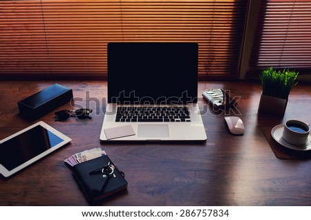 Freelancer needs workstation with accessories and euro bills, open laptop computer and digital tablet with blank screen, on-line learning or distance work, modern businessman table with copy space