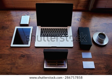 Successful businessman or entrepreneur workspace with style accessories, pen case, open laptop computer and digital tablet with white blank copy space screen, private office table of wealthy person