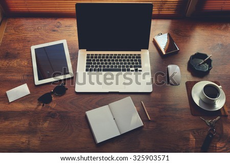 Mock up of rich business person workplace with luxury accessories and distance work tools, laptop computer and digital tablet with blank copy space for text message or information content