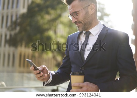 Similar – Foto Bild Gut gekleideter Mann beim Surfen auf dem Smartphone in der Stadt