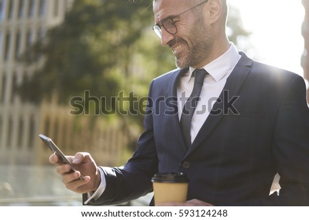 Similar – Foto Bild Gut gekleideter Mann beim Surfen auf dem Smartphone in der Stadt