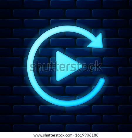 Glowing neon Video play button like simple replay icon isolated on brick wall background.  Vector Illustration