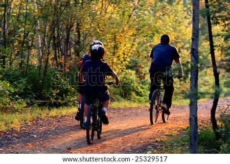 family bike riding in the woods
