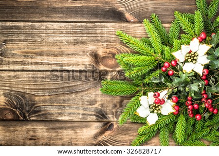 Beautiful christmas background with spruce tree and decoration on rustic wood.