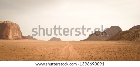 Landscape view of dusty road going far away nowhere in Wadi Rum desert, Jordan