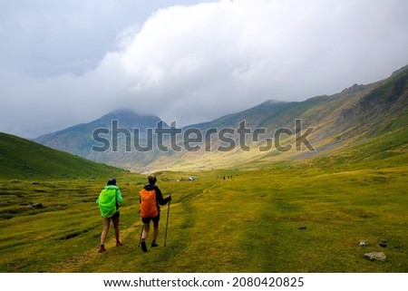 Similar – Image, Stock Photo Silhouettes pair walking through tunnel towards the sun