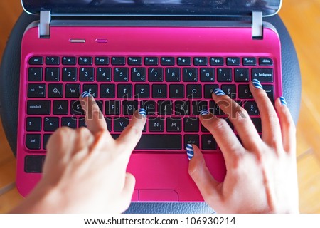 Girl hands on keyboard typing word \