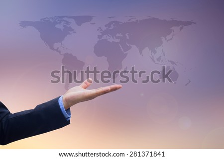 Businessman's hand showing map of the world on blurred twilight sky, selective focused.business concept
