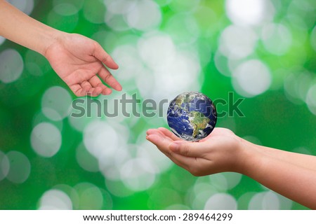 hands receive the world for heal together on blurred green nature backgrounds, safe the world concept ,Elements of this image furnished by NASA