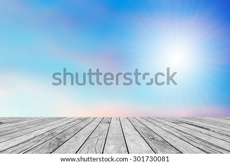 old vintage wooden desk table with blurred early morning sky backgrounds with sunny light.put and show your products on this backgrounds.pastel tone styles.