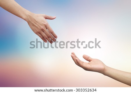 helping hand and hands praying on blurred beautiful twilight sky backgrounds. helping hand concept.hand of god giving the power to human\'s hand.
