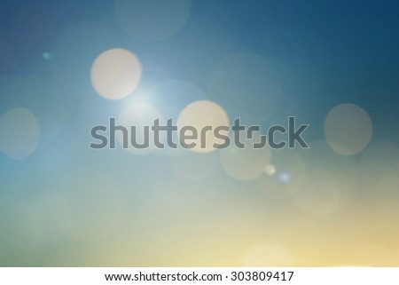 abstract blurred backgrounds of sea with circle lights : abstract colorful of blue and yellow tone.