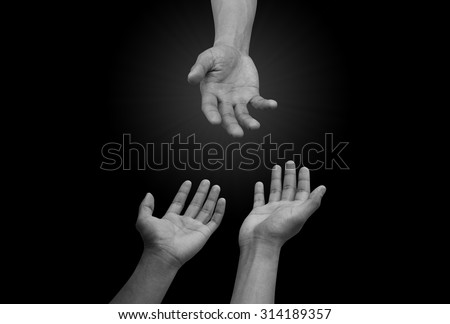 helping hand and hands praying isolated on black backgrounds. helping hand concept.hand of god giving the power to human\'s hand.religion concept.