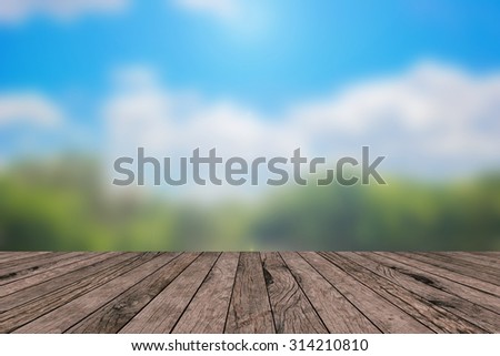 Blurred nature park outdoors backgrounds vintage with wooden desk table or wooden paving : blurred of nature park  with shiny sunlight in a day .put and show your products on this backgrounds