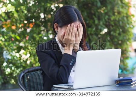 close up business woman feeling serious with her job at outside office : working woman thoughtful and stress : business woman concept,working depression concept.