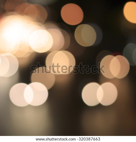Abstract blurred traffic  bokeh circle light backgrounds : blurred night city in warm tone colour :blurred backgrounds concept.out of focused concept.