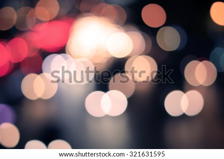 Abstract blurred colorful of traffic circle light backgrounds:blurred night city with colour bokeh light :blur circle light christmas festive backdrop concept:blur background in vintage tone colored.