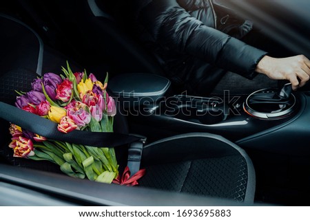 Similar – Foto Bild Blumenstrauß neben Frauenbeinen auf Beifahrerseite im Auto