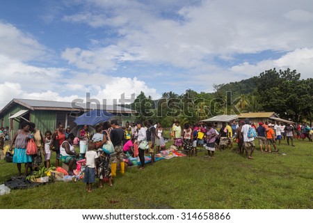 Batuna, Solomon Islands - May 28, 2015: People buying and selling food at the local market in the village of Batuna.