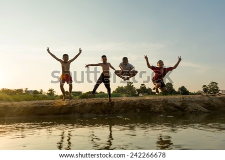 01 january 2015; group of happy asia young people jumping  at the beach on beautiful summer sunset,bangkok thailand