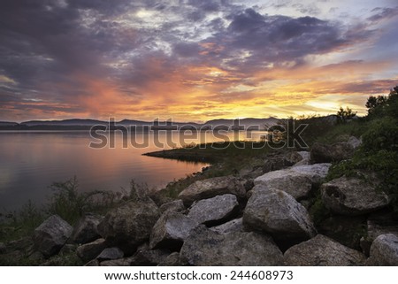 Colorful sunset at the rocks and Silhouettes landscape view sunset Water reflection