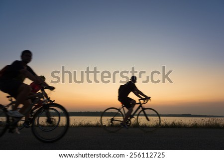 blur and movement riding their bikes or bicycles in their free time and having fun on a sunny summer day