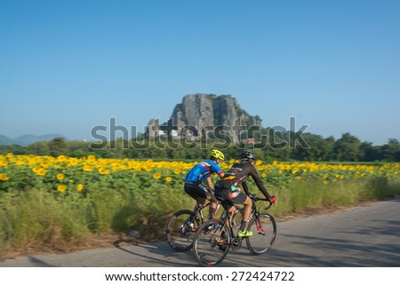 22 April 2015:movement riding their bikes or bicycles in their free time and having fun on a sunny summer day at Lopburi, Thailand